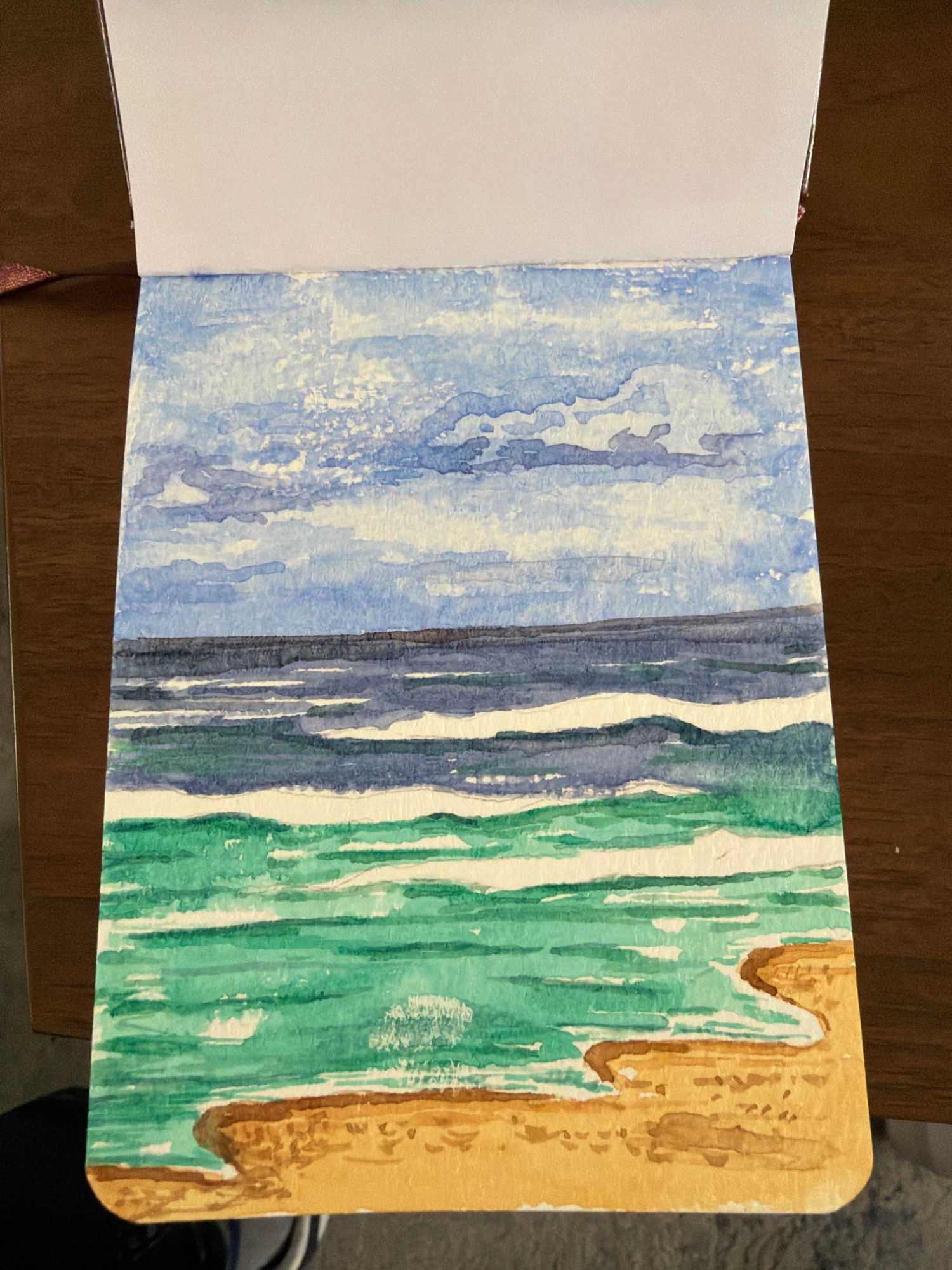 Seascape watercolor with deeper clouds and more detail in the sea and sand